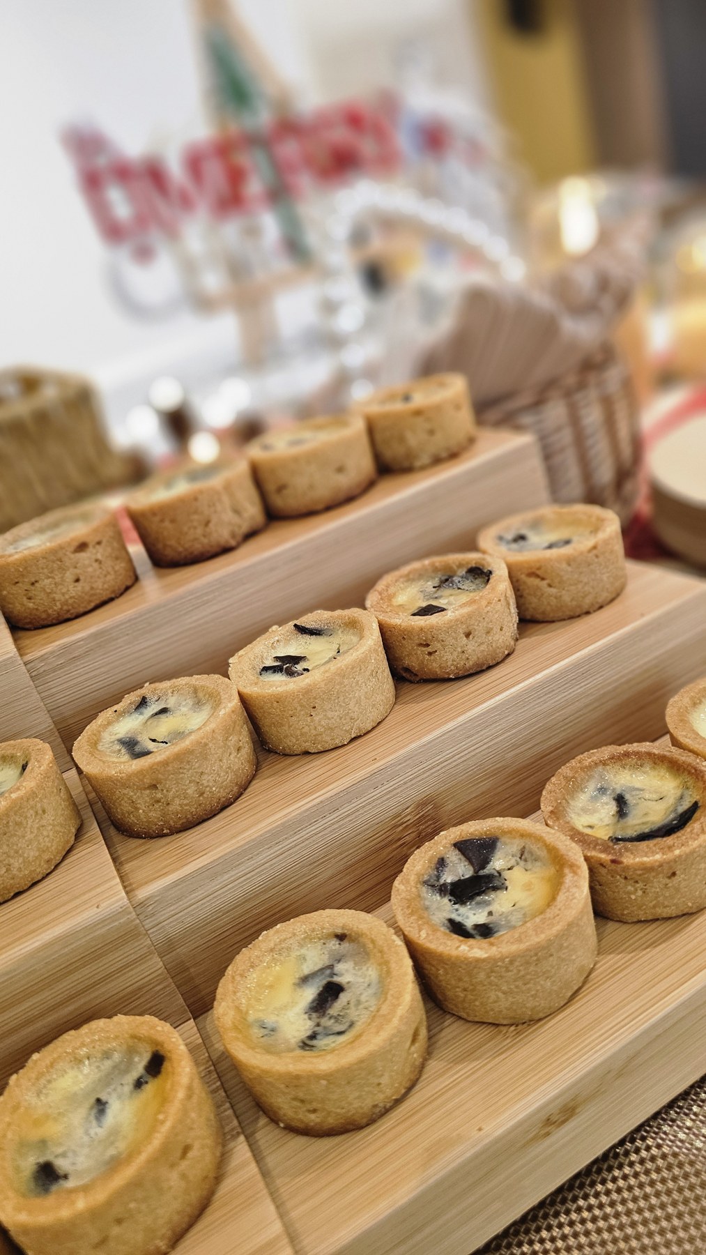 Baked tartlets arranged on tiered wooden display stands