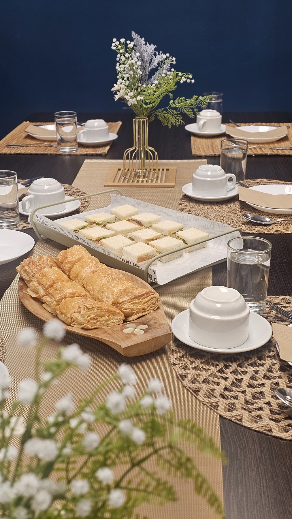 Tea, pastries and sandwiches arranged for a refreshment break