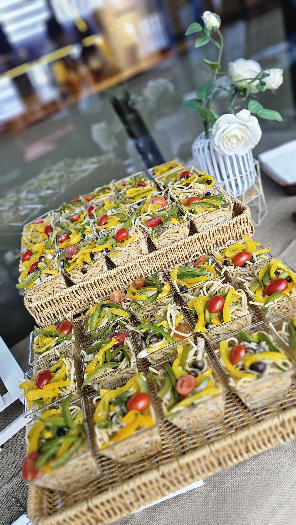Colourful canapés arranged on woven buffet stands