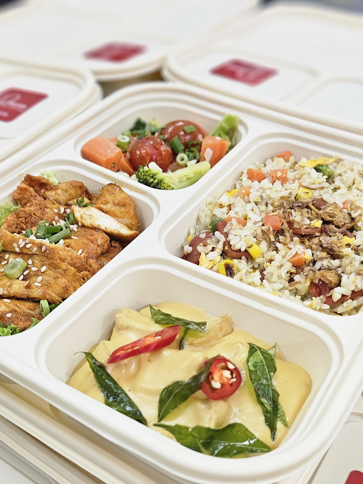 Freshly packed bento meals with rice, vegetables and chicken